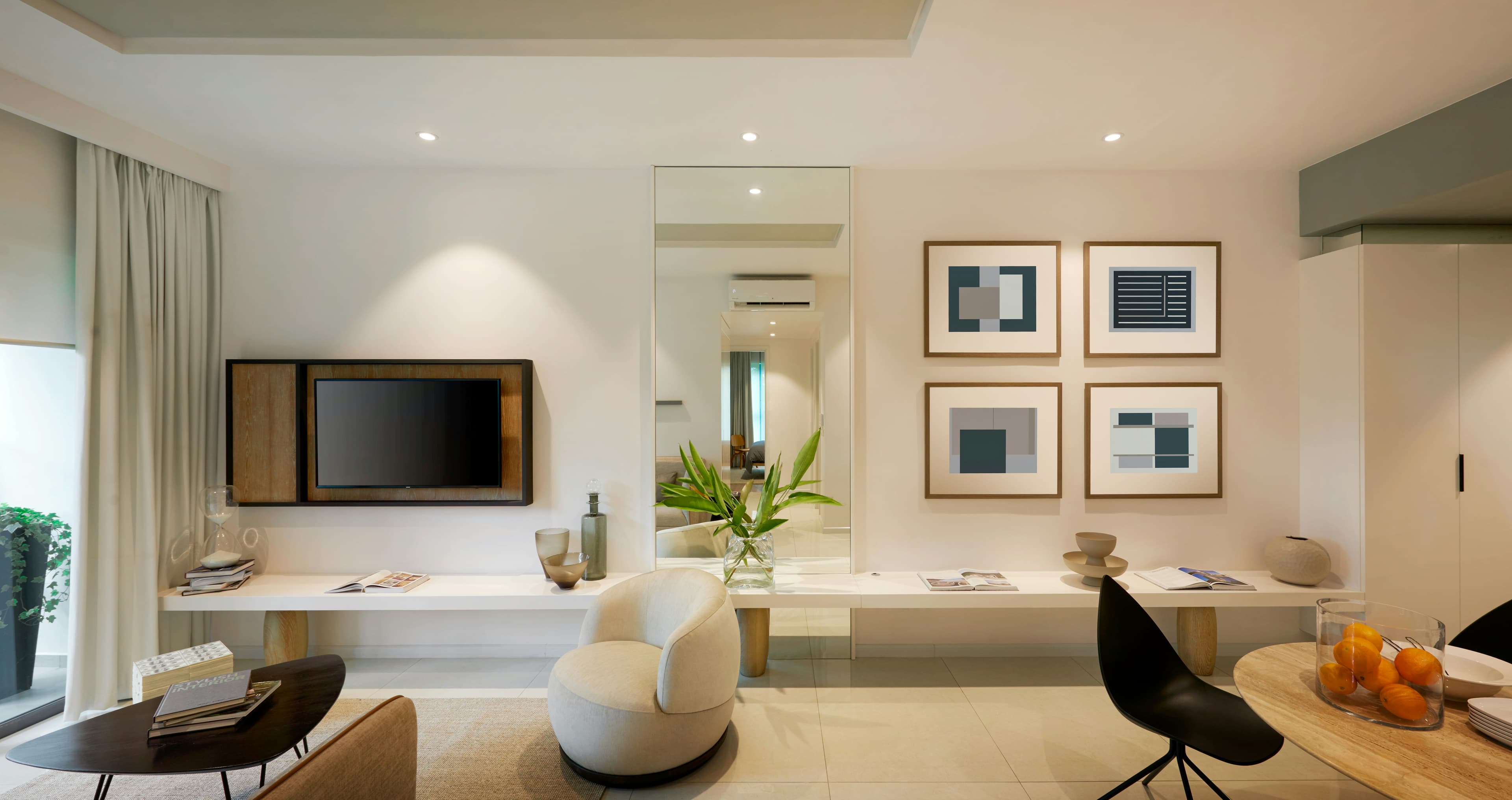 Modern living room with a wall-mounted television and gallery wall